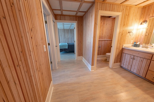 4569 N Ridge Rd, Mears, MI 49436 - ensuite bathroom with vanity, wood finished floors, and wooden walls