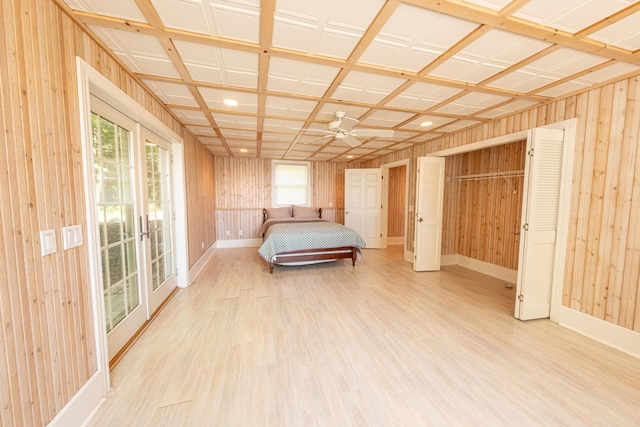 4569 N Ridge Rd, Mears, MI 49436 - unfurnished bedroom featuring light wood finished floors, multiple windows, wood walls, access to outside, and recessed lighting