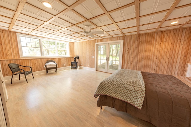 4569 N Ridge Rd, Mears, MI 49436 - bedroom with a wood stove, wood finished floors, wooden walls, and access to outside
