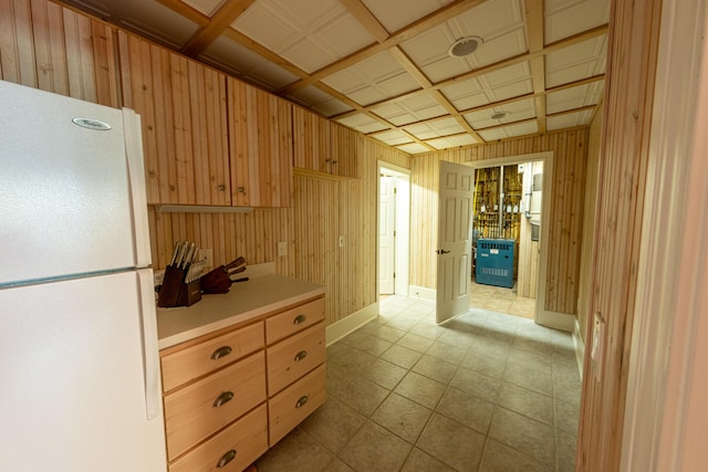 4569 N Ridge Rd, Mears, MI 49436 - kitchen with freestanding refrigerator, wooden walls, and light countertops