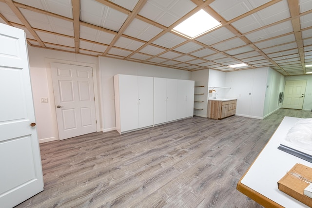 4569 N Ridge Rd, Mears, MI 49436 - below grade area with baseboards and light wood-style floors