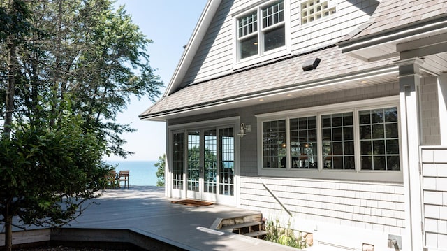 4569 N Ridge Rd, Mears, MI 49436 - view of side of property featuring a deck with water view and roof with shingles