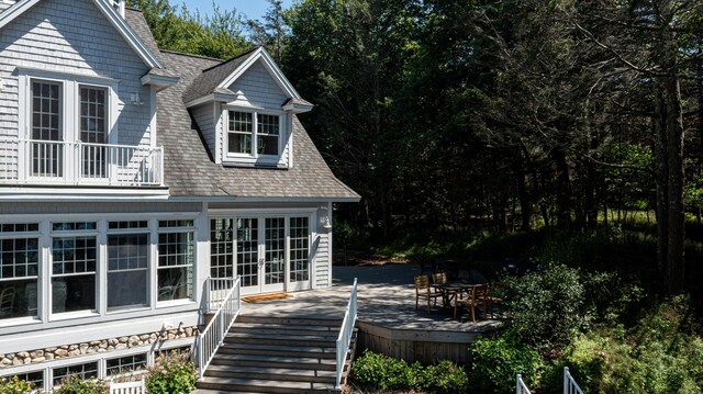 4569 N Ridge Rd, Mears, MI 49436 - rear view of house featuring a shingled roof and a wooden deck