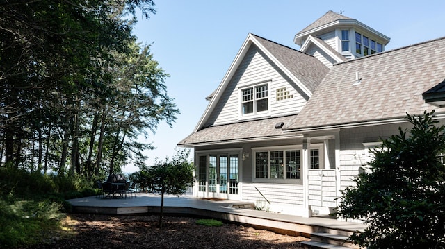 4569 N Ridge Rd, Mears, MI 49436 - rear view of house featuring french doors, a shingled roof, and a wooden deck