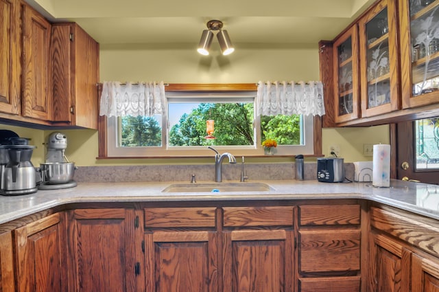 3914 135th Ave, Hersey, MI 49639 - kitchen with light countertops, glass insert cabinets, and brown cabinets