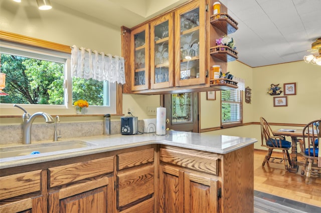 3914 135th Ave, Hersey, MI 49639 - kitchen with plenty of natural light, brown cabinetry, glass insert cabinets, and a peninsula