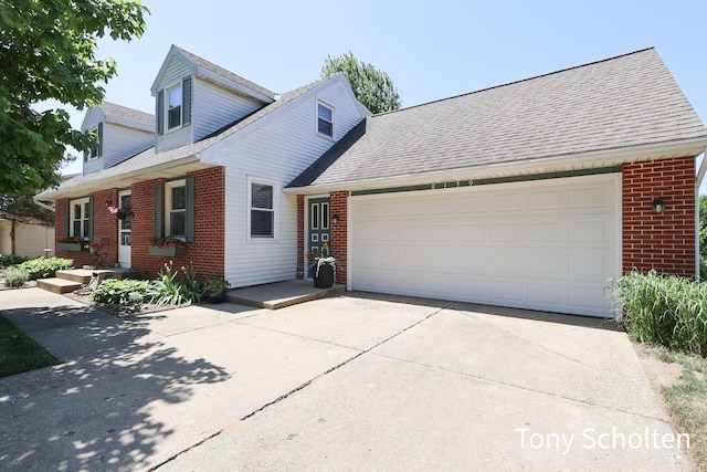 8179 Mellowwood Dr, Jenison, MI 49428 - traditional home with brick siding, concrete driveway, roof with shingles, and an attached garage
