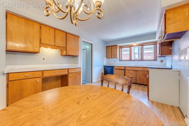 8571 Linda St, Warren, MI 48093 - kitchen with light wood-style floors, brown cabinets, a chandelier, light countertops, and decorative backsplash
