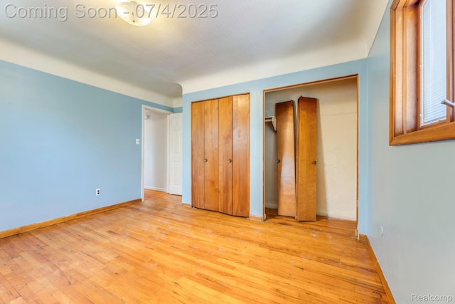 8571 Linda St, Warren, MI 48093 - unfurnished bedroom featuring multiple closets and light wood-style floors
