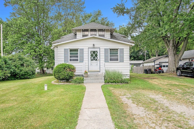 240 Stillwell Ave, Michigan Center, MI 49254 - bungalow-style home featuring entry steps and a shingled roof