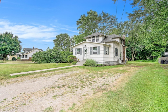 240 Stillwell Ave, Michigan Center, MI 49254 - view of front of home with a chimney and a front lawn
