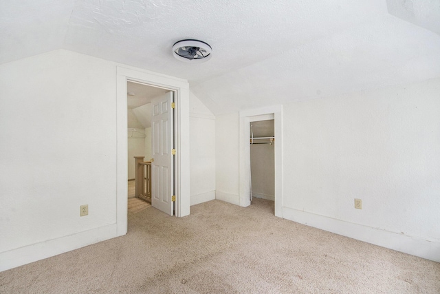240 Stillwell Ave, Michigan Center, MI 49254 - unfurnished bedroom with lofted ceiling, carpet, and a closet