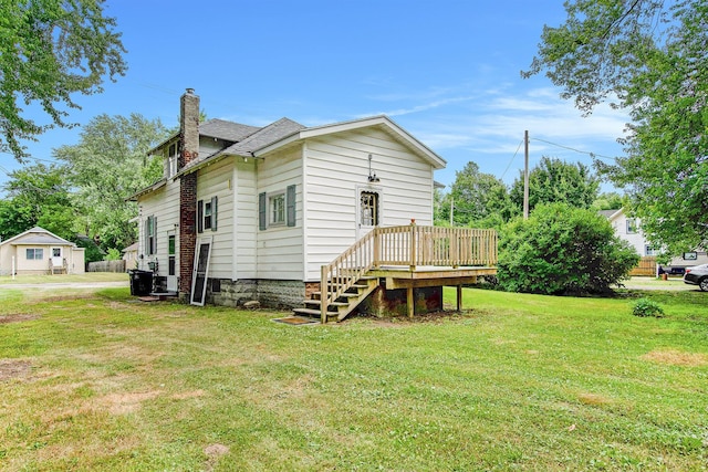 240 Stillwell Ave, Michigan Center, MI 49254 - rear view of property with a chimney, a yard, a deck, and roof with shingles