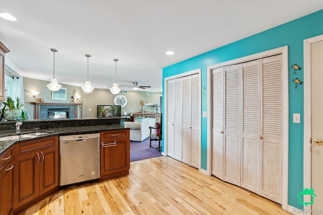 2340 Lakeview Dr, Brooklyn, MI 49230 - kitchen featuring stainless steel dishwasher, a premium fireplace, brown cabinetry, light wood-style flooring, and open floor plan
