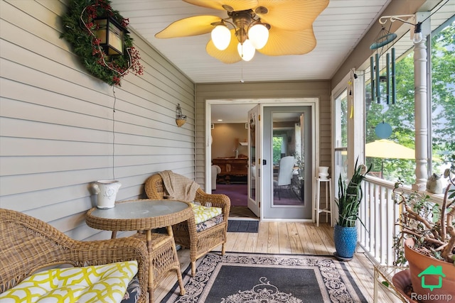 2340 Lakeview Dr, Brooklyn, MI 49230 - sunroom / solarium with hardwood / wood-style floors, a ceiling fan, and wooden walls