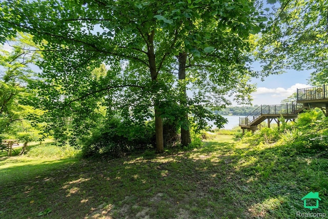 2340 Lakeview Dr, Brooklyn, MI 49230 - view of yard featuring stairway and a deck with water view