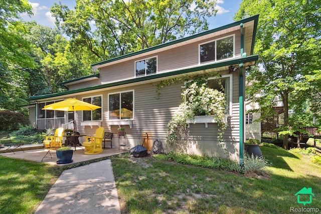 2340 Lakeview Dr, Brooklyn, MI 49230 - view of front of house with a patio, a front lawn, and a sunroom