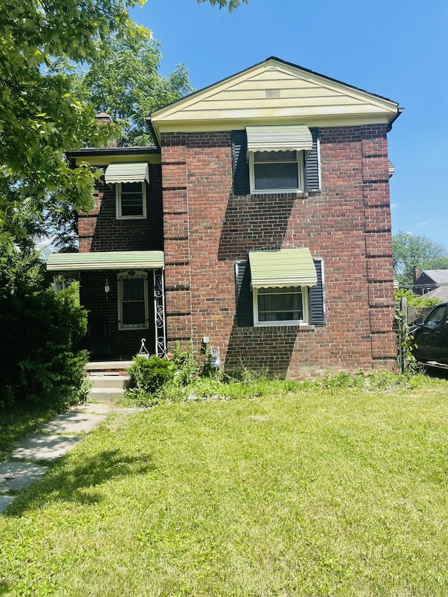 2955 Ewald Cir, Detroit, MI 48238 - view of front of house featuring a front lawn, brick siding, and a porch