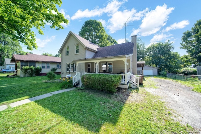 216 Budlong St, Adrian, MI 49221 - traditional-style home with covered porch, a chimney, and an outbuilding