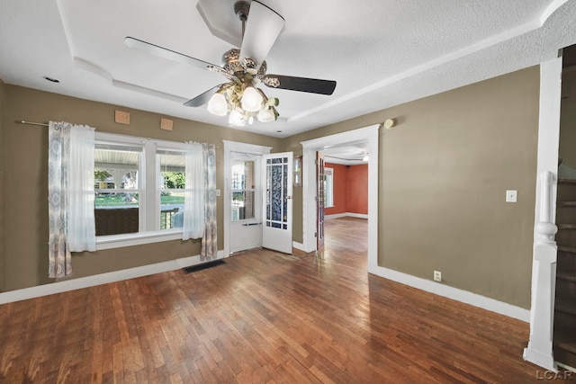 216 Budlong St, Adrian, MI 49221 - empty room with plenty of natural light, a ceiling fan, and hardwood / wood-style flooring