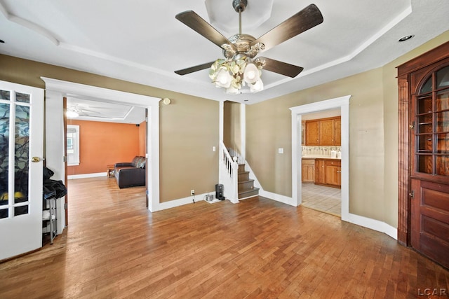 216 Budlong St, Adrian, MI 49221 - unfurnished room featuring a ceiling fan, stairway, and light wood-style flooring