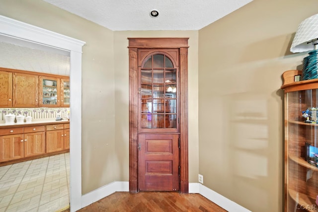 216 Budlong St, Adrian, MI 49221 - foyer with baseboards and light wood-style flooring