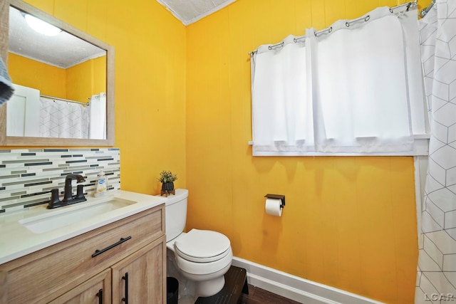 216 Budlong St, Adrian, MI 49221 - full bathroom with vanity, decorative backsplash, wood finished floors, and crown molding
