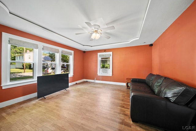 216 Budlong St, Adrian, MI 49221 - living room featuring a raised ceiling, healthy amount of natural light, and light wood-style floors