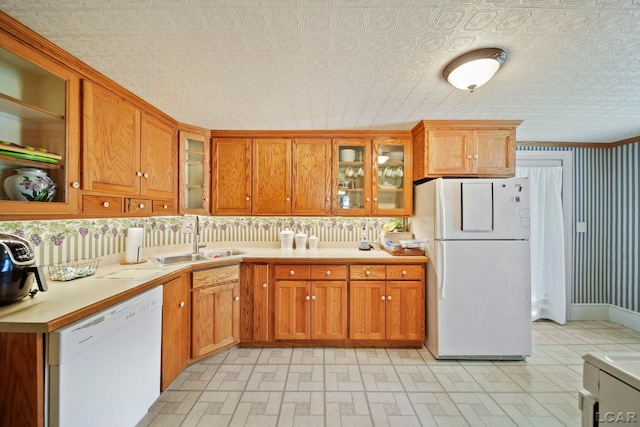 216 Budlong St, Adrian, MI 49221 - kitchen featuring white appliances, brown cabinetry, light countertops, glass insert cabinets, and an ornate ceiling