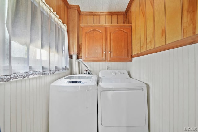 216 Budlong St, Adrian, MI 49221 - washroom with cabinet space, independent washer and dryer, wooden walls, and wallpapered walls