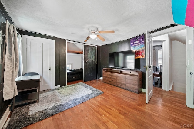 216 Budlong St, Adrian, MI 49221 - living room with a textured ceiling, wood finished floors, and a ceiling fan