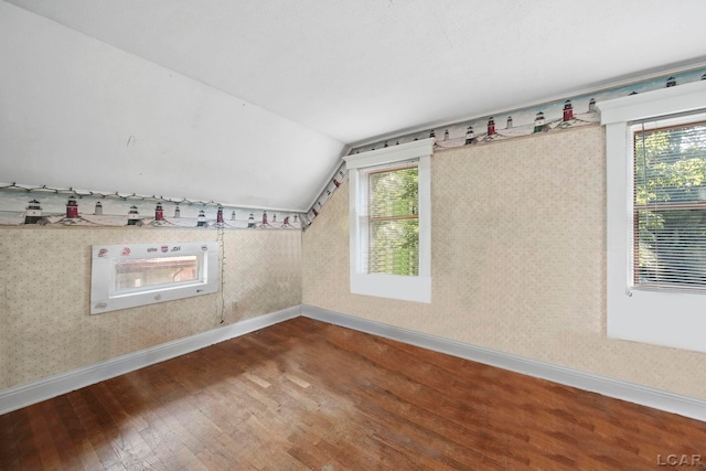 216 Budlong St, Adrian, MI 49221 - bonus room featuring wood finished floors, vaulted ceiling, and wallpapered walls