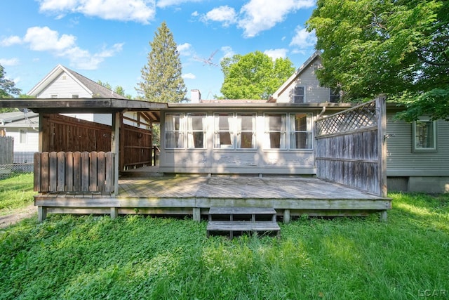 216 Budlong St, Adrian, MI 49221 - rear view of property with a wooden deck, a chimney, and a sunroom