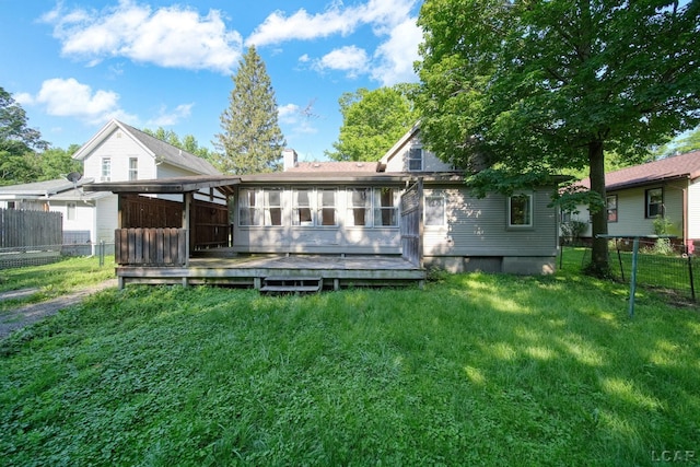 216 Budlong St, Adrian, MI 49221 - back of property featuring a wooden deck, a sunroom, and a chimney