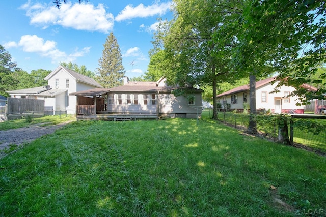 216 Budlong St, Adrian, MI 49221 - back of property with a fenced backyard and a sunroom