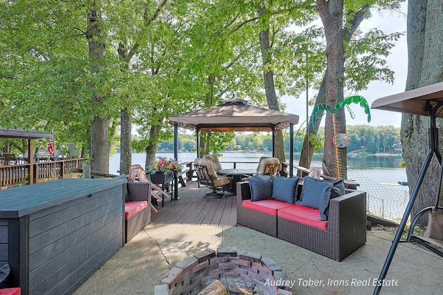 5190 N Bass Lake Rd, Irons, MI 49644 - wooden deck with a gazebo, a water view, and an outdoor living space with a fire pit