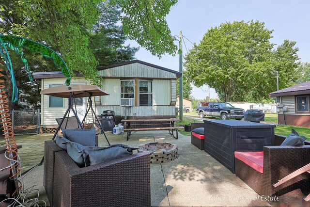 5190 N Bass Lake Rd, Irons, MI 49644 - view of patio / terrace with a deck, area for grilling, and an outdoor living space with a fire pit