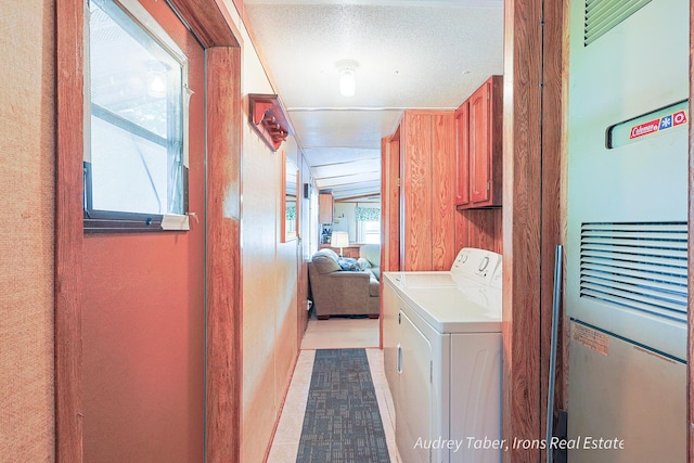 5190 N Bass Lake Rd, Irons, MI 49644 - laundry area with a heating unit and cabinet space