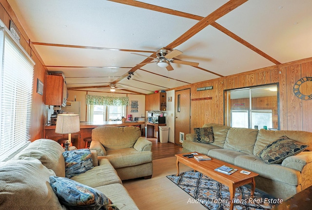 5190 N Bass Lake Rd, Irons, MI 49644 - living room with wood finished floors, ceiling fan, and wood walls