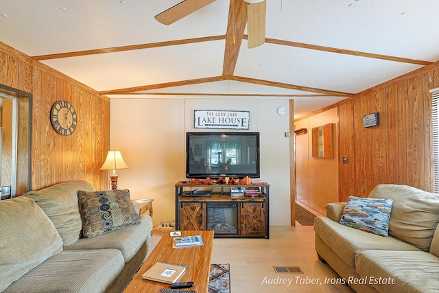 5190 N Bass Lake Rd, Irons, MI 49644 - living area featuring wooden walls, light wood finished floors, and ceiling fan