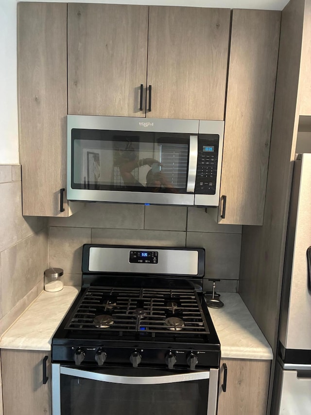 451 Martin Luther King Jr Blvd N, Pontiac, MI 48342 - kitchen with appliances with stainless steel finishes, light countertops, and decorative backsplash