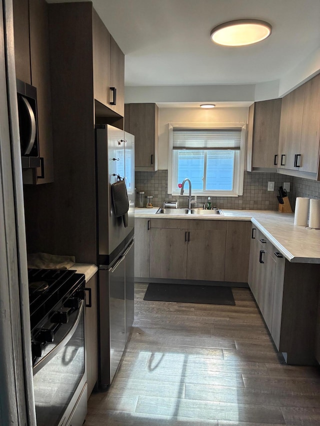 451 Martin Luther King Jr Blvd N, Pontiac, MI 48342 - kitchen with appliances with stainless steel finishes, light countertops, tasteful backsplash, and dark wood-style flooring