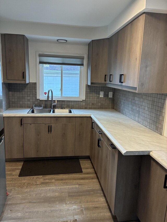451 Martin Luther King Jr Blvd N, Pontiac, MI 48342 - kitchen with light countertops, wood finished floors, and tasteful backsplash