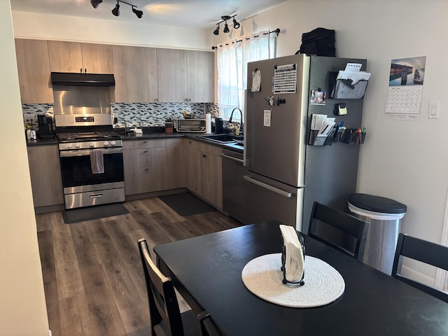 221 N Lakeview Ave, Sturgis, MI 49091 - kitchen with appliances with stainless steel finishes, dark countertops, under cabinet range hood, and tasteful backsplash