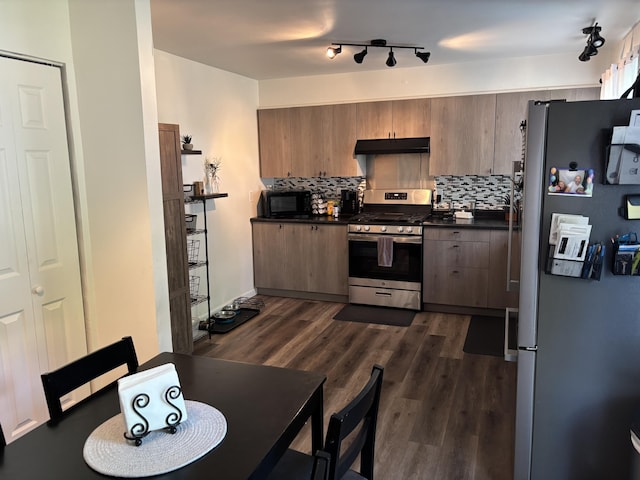 221 N Lakeview Ave, Sturgis, MI 49091 - kitchen featuring stainless steel appliances, under cabinet range hood, dark countertops, and tasteful backsplash