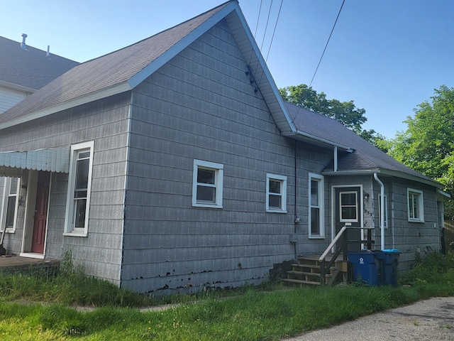 233 2nd Ave, Manistee, MI 49660 - back of house featuring roof with shingles