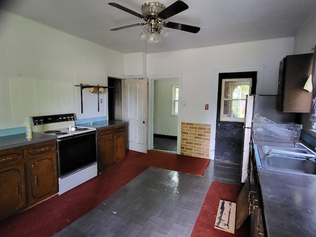 233 2nd Ave, Manistee, MI 49660 - kitchen with electric stove, ceiling fan, and dark countertops