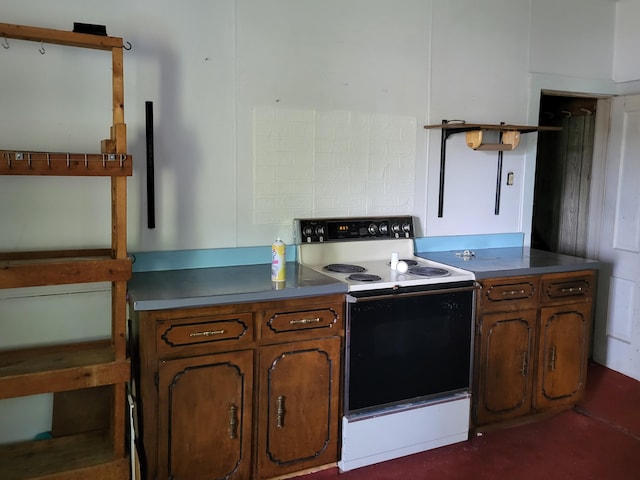 233 2nd Ave, Manistee, MI 49660 - kitchen featuring white range with electric stovetop and brown cabinets
