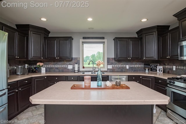 15946 Tubspring Rd, Allenton, MI 48002 - kitchen with appliances with stainless steel finishes, light countertops, recessed lighting, decorative backsplash, and a center island