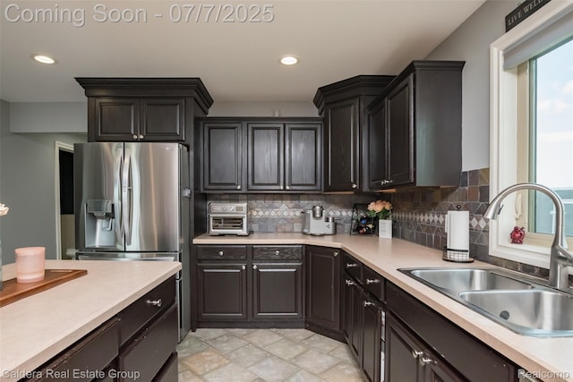 15946 Tubspring Rd, Allenton, MI 48002 - kitchen featuring light countertops, tasteful backsplash, stainless steel refrigerator with ice dispenser, and recessed lighting